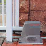 Installed automatic sliding gate motor on driveway with SAMT branding, Prestons, New South Wales, Australia.