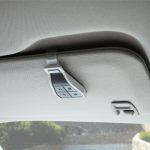 Remote control securely clipped onto a car sun visor for convenient gate or garage operation, photographed in Prestons, New South Wales, Australia