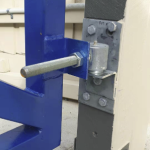 Lower hinge bolt and plate assembly for a blue metal gate attached to a grey steel post, shown in Prestons, New South Wales, Australia