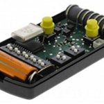 Internal view of Nice black remote control with exposed circuit board, battery, and yellow buttons, used for gate automation in Prestons, New South Wales, Australia.